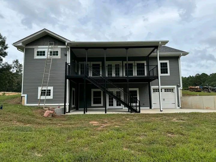 A two storey nutec apartment fully completed and with a grey finish exterior paint
